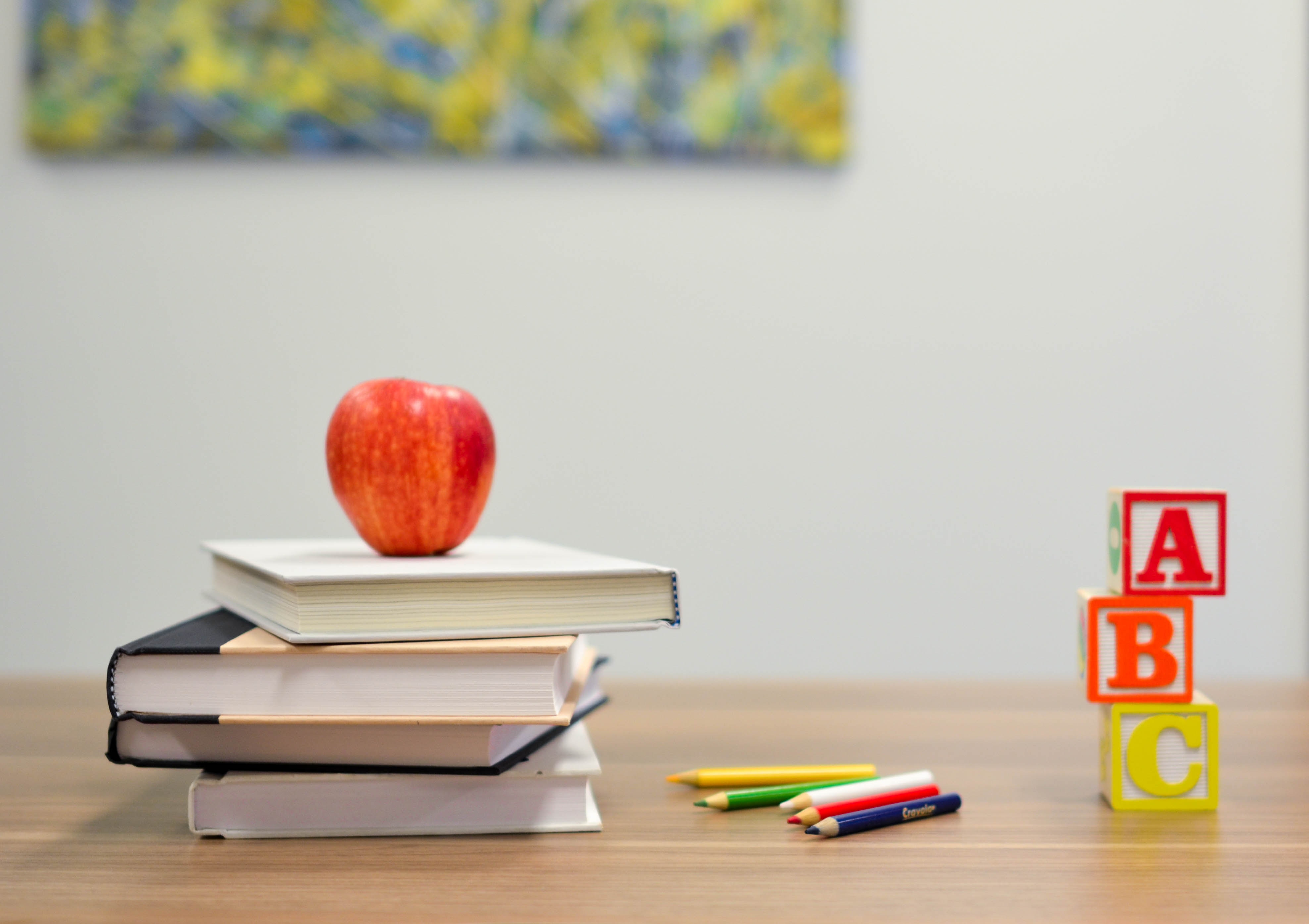 Apple, books, pencils, and blocks