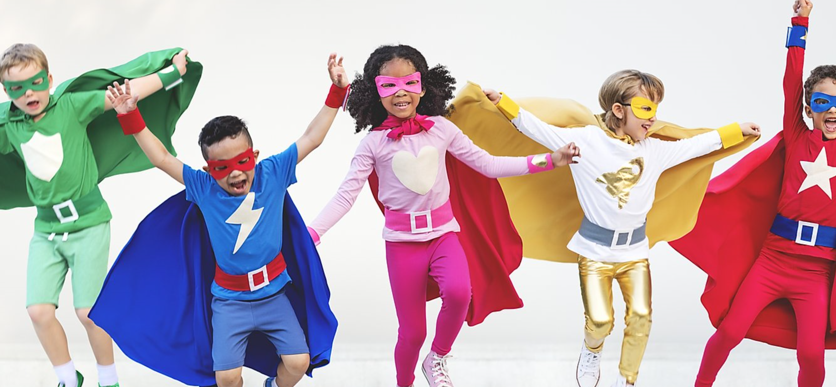 Children jumping in superhero costumes