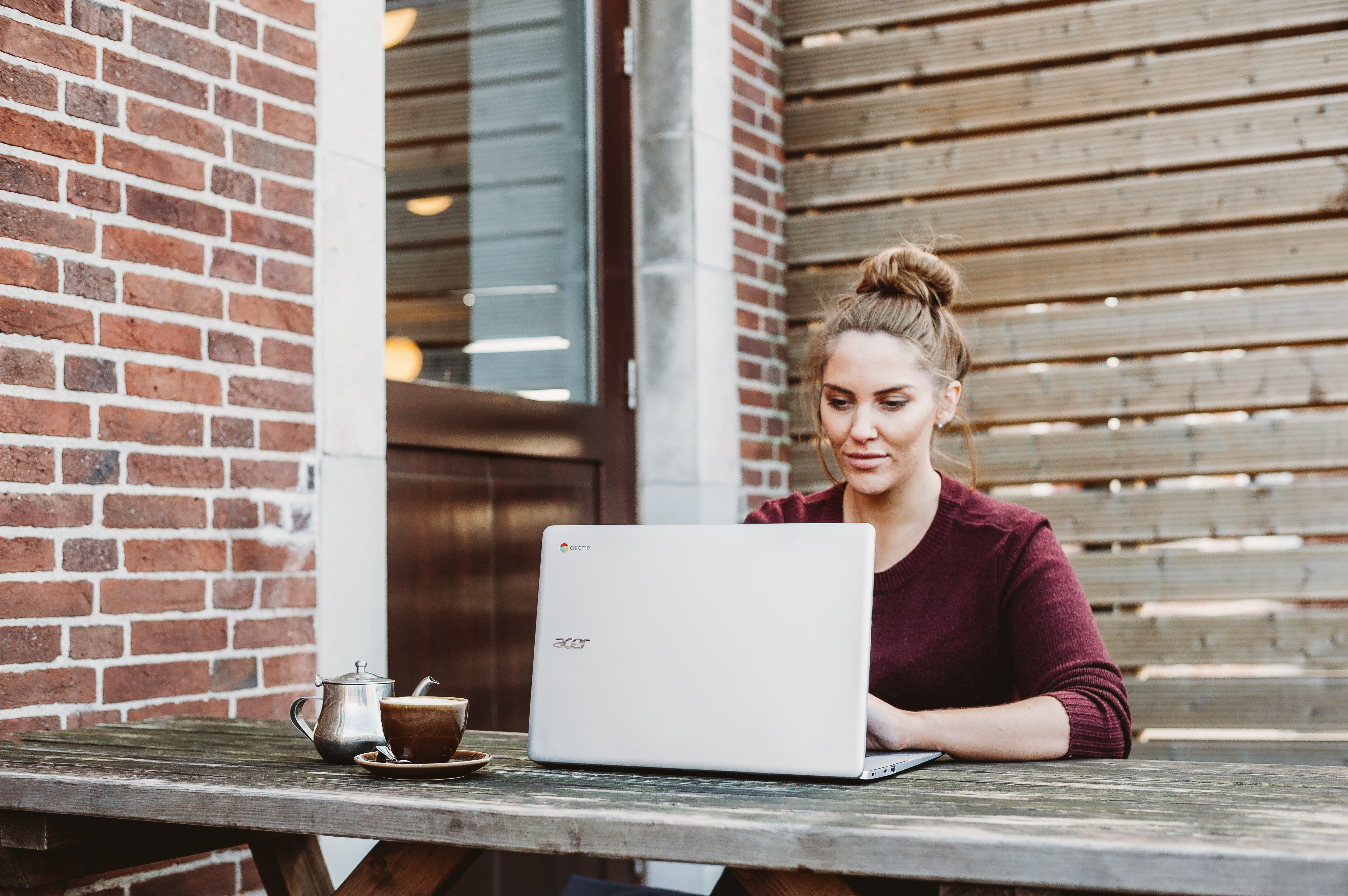 Woman working on laptop outside