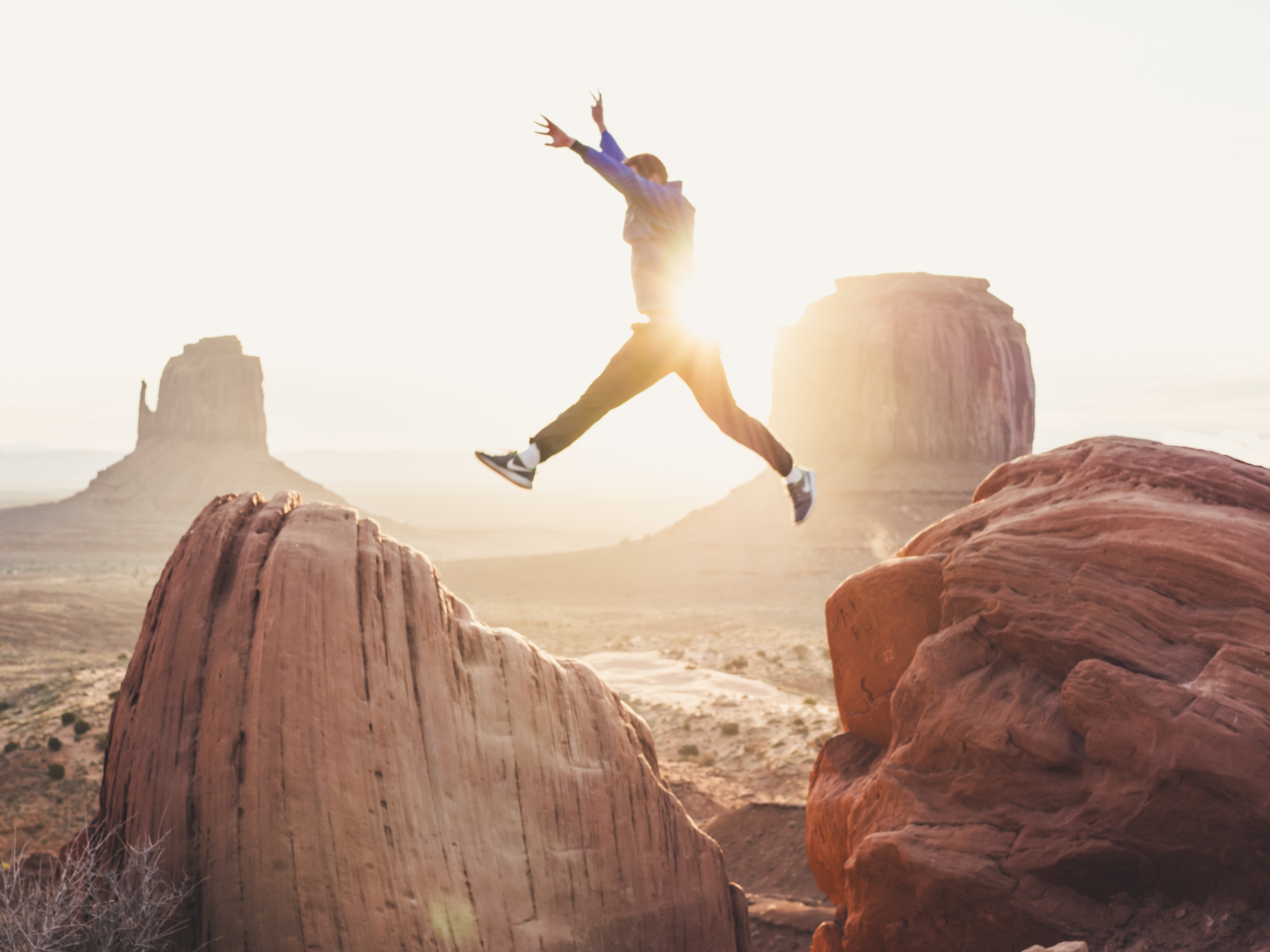 Person jumping between rocks